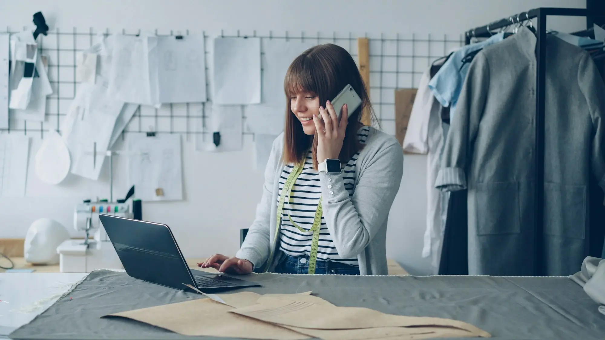 Fashion business owner planning on the phone in her quiet studio