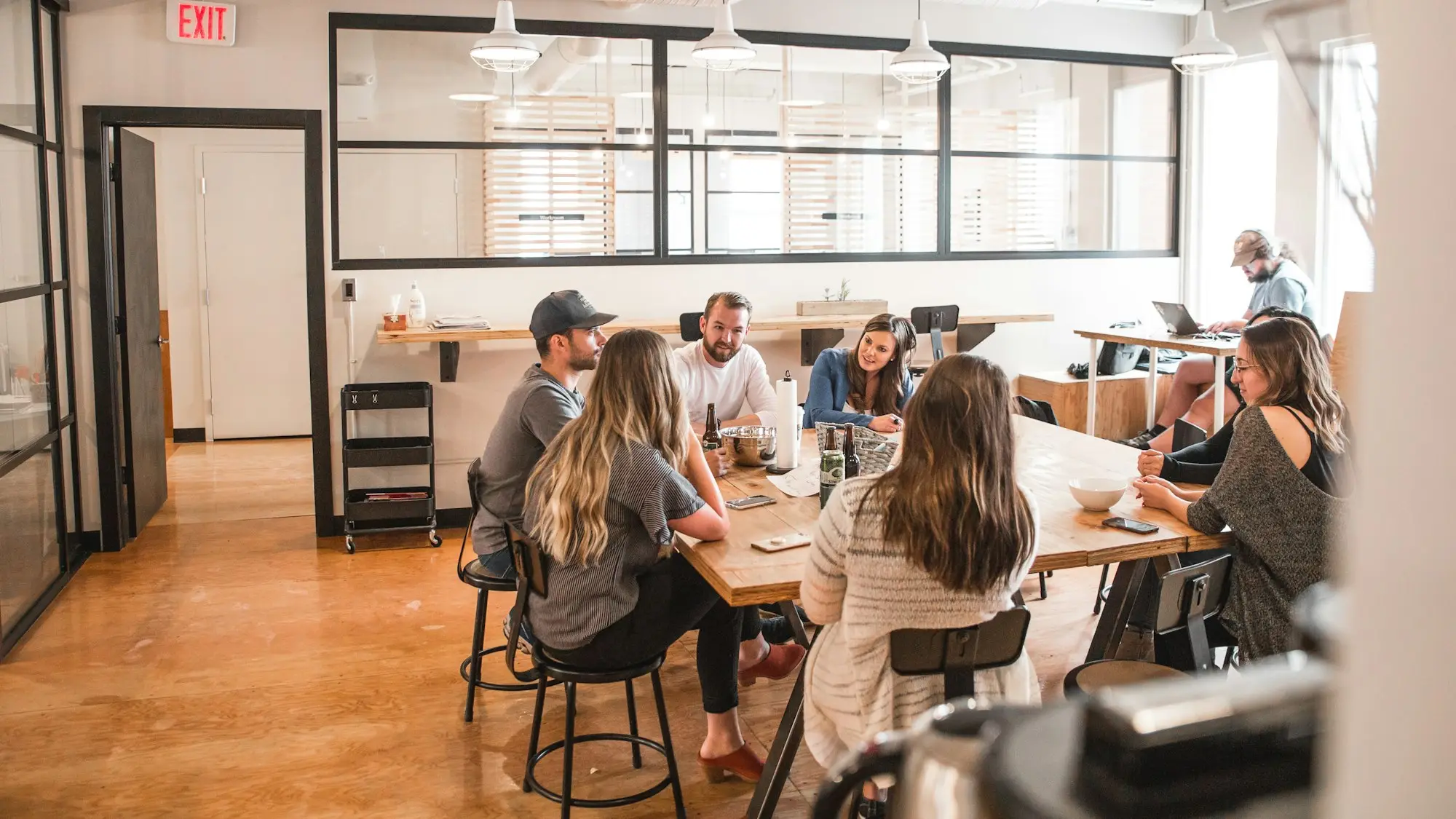 Professional team meeting around tables in an office