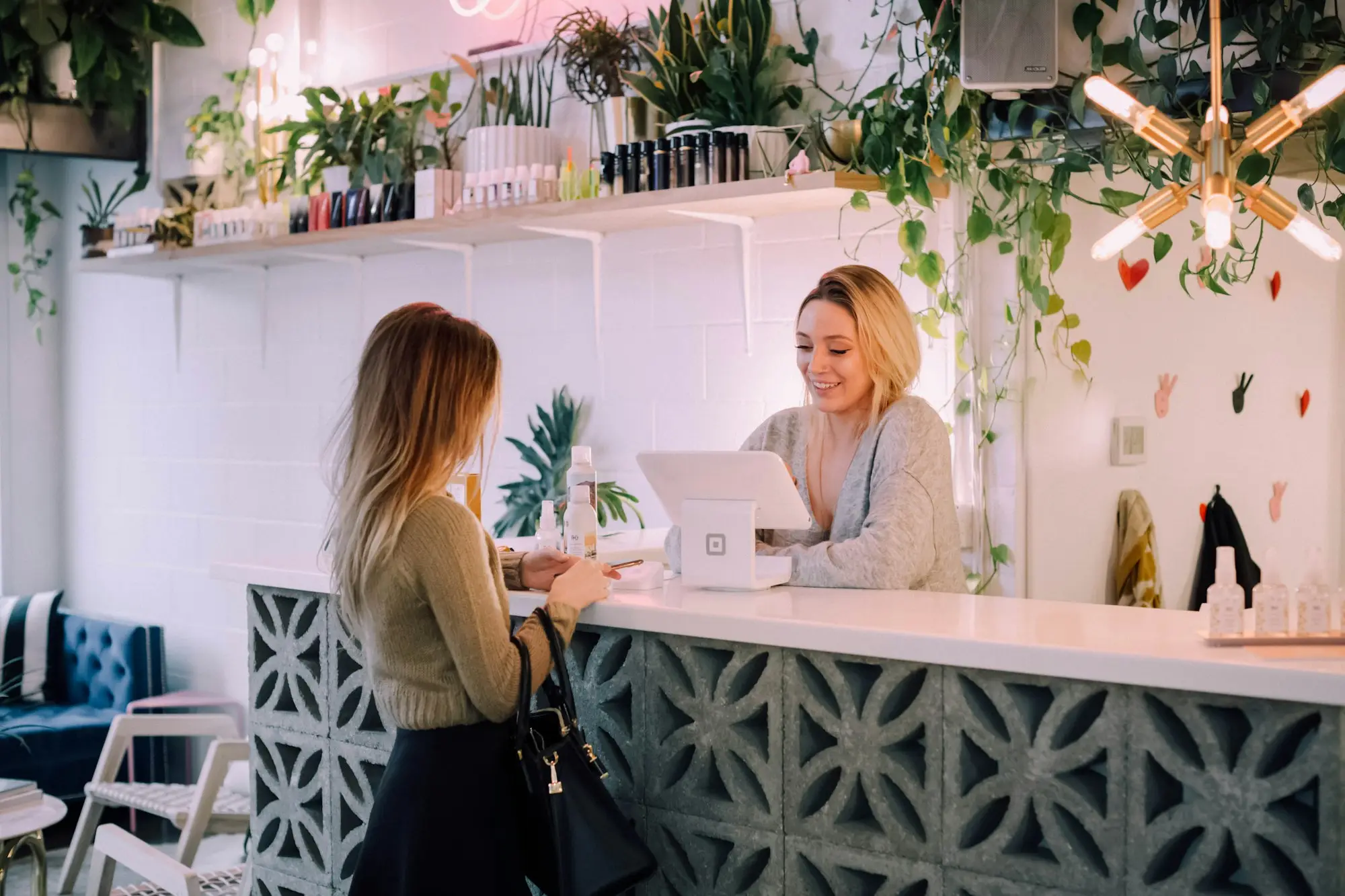 Boutique owner serving a customer at the counter